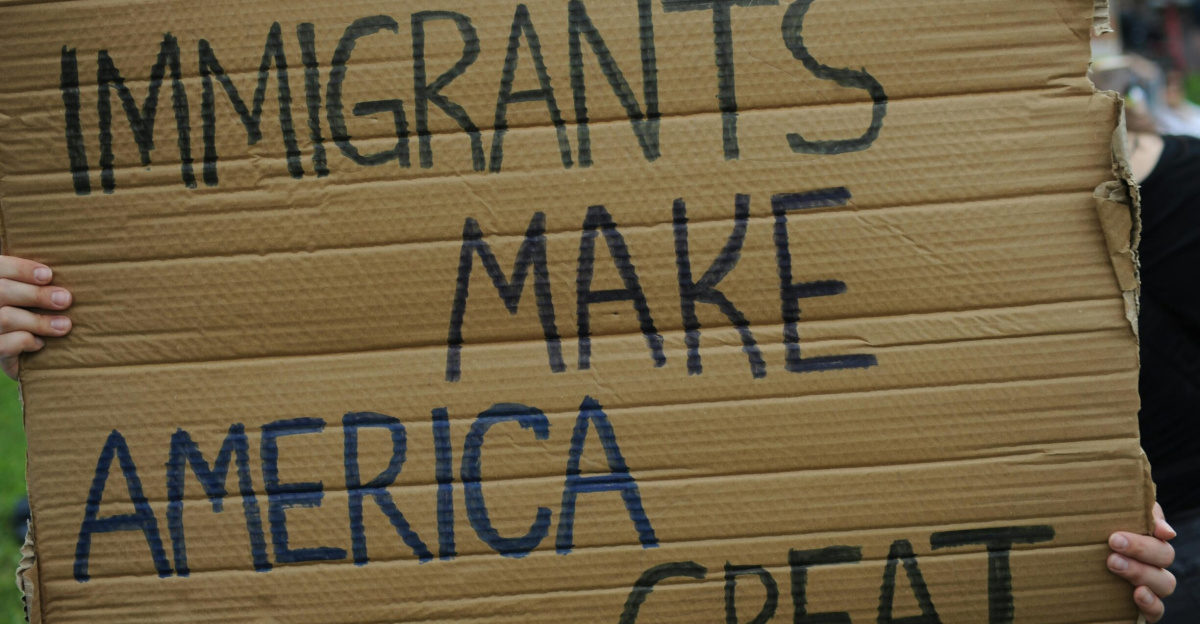 Close-up of sign reading 'Immigrants Make America Great' at a Baltimore rally.