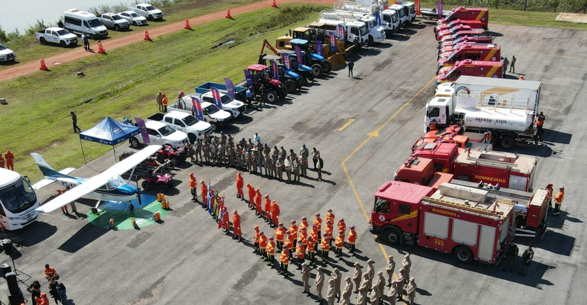 Aerial view of a firefighter training event showcasing various emergency vehicles and personnel in formation.