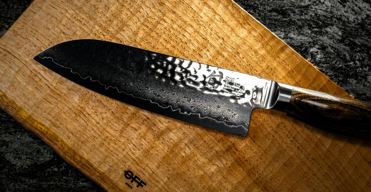 High-quality Santoku knife displayed on a textured wooden board, ideal for culinary settings.