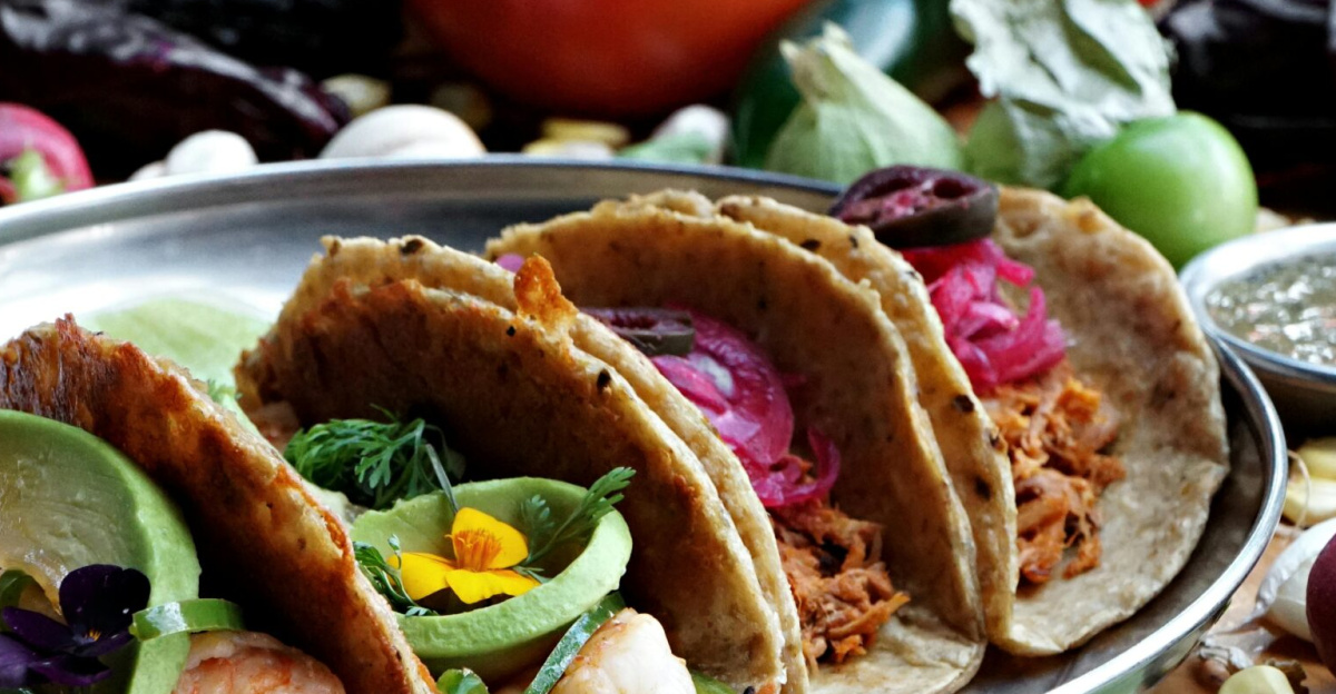Vibrant display of varied Mexican tacos featuring fresh ingredients and colorful garnishes, perfect for food lovers.