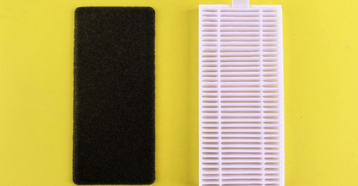 Black foam filter and white air filter on bright yellow backdrop showcasing air purification essentials.