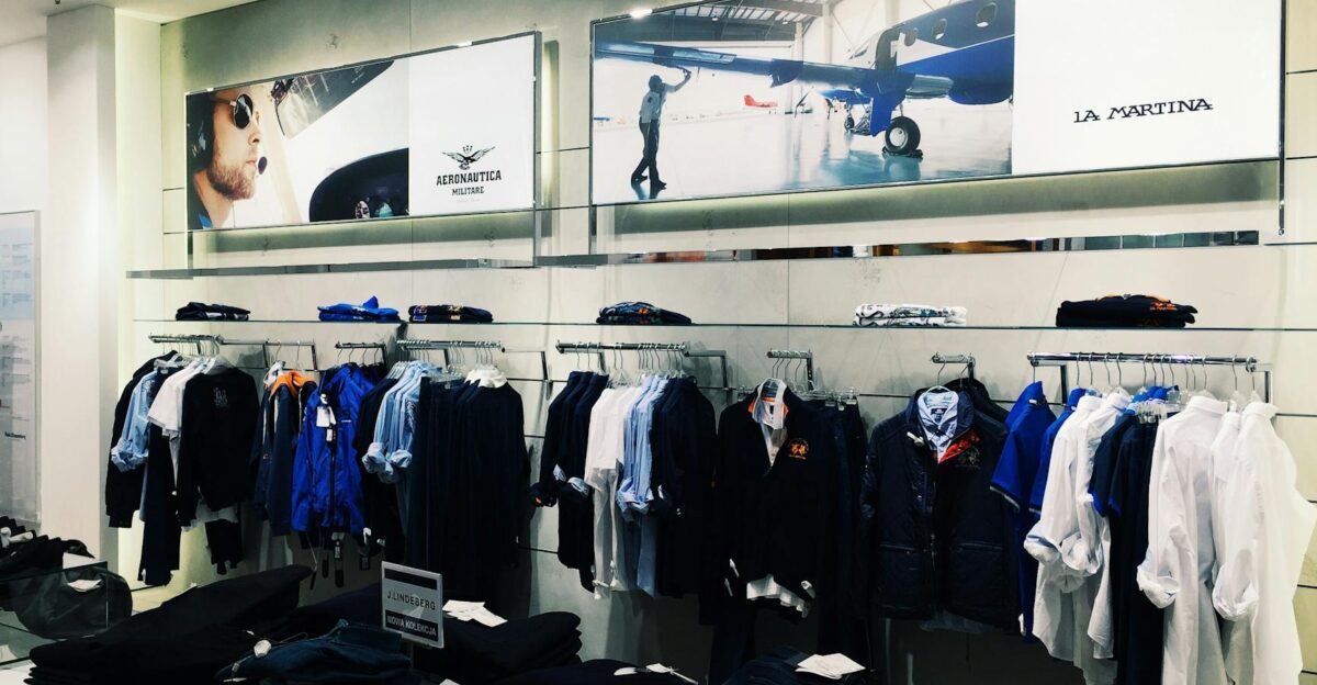 Interior view of a stylish boutique showcasing La Martina clothing line with organized retail display
