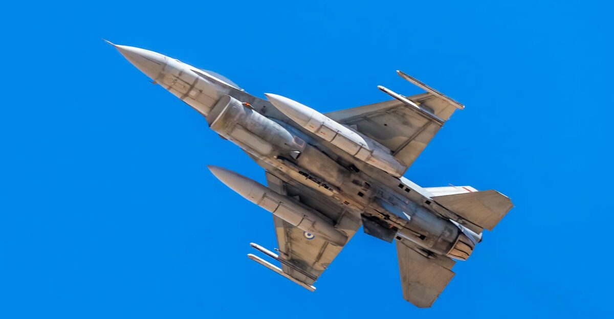 F-16 military jet flying under clear blue skies showcasing maneuverability and power