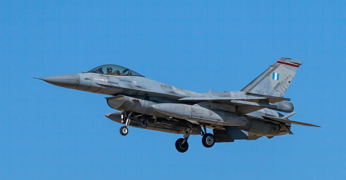 F-16 fighter jet flying against a clear blue sky showcasing military aviation power