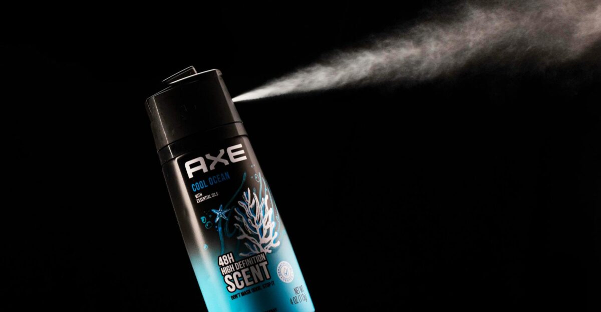 Axe Cool Ocean body spray emitting mist against a dark background