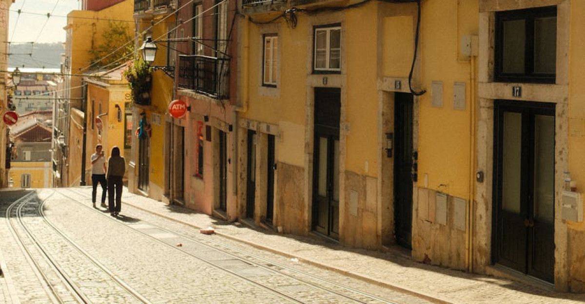 Charming street view in Lisbon with historic colorful buildings and tram tracks