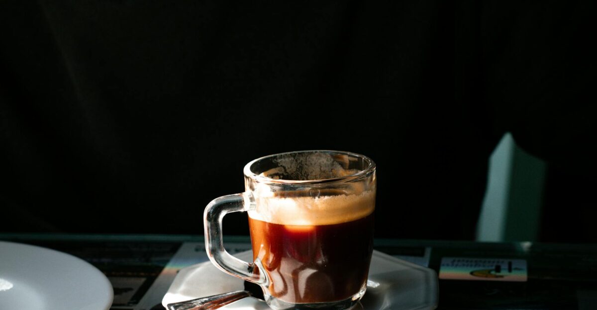 A close-up of an espresso coffee served in a clear glass cup on a sunny day in S o Paulo Brazil