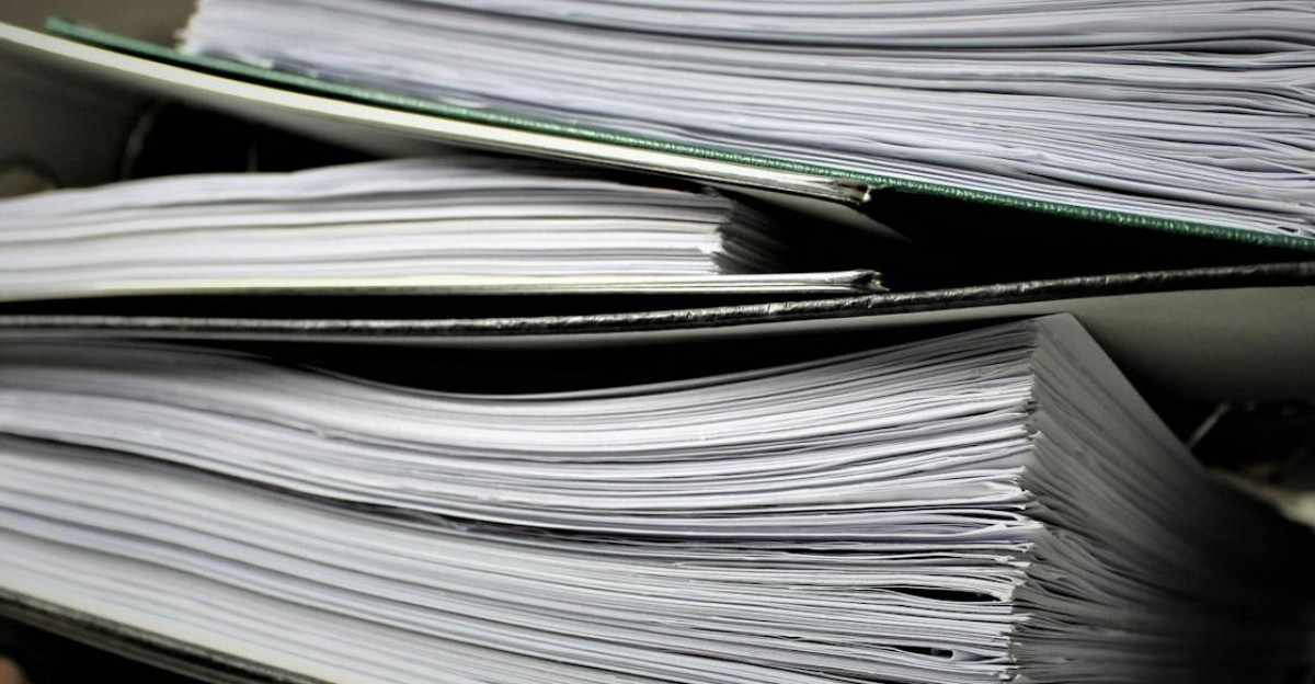 Close-up of stacked binders filled with documents for office or educational use
