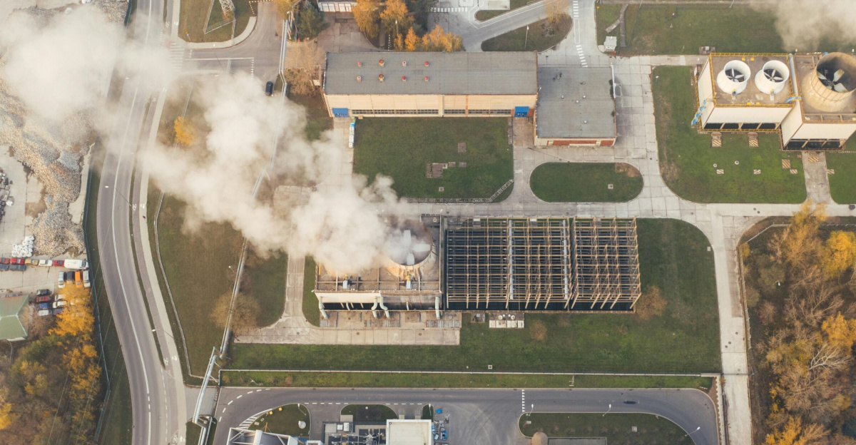 Aerial shot of an industrial area with visible smoke emissions in Poznań, Poland.