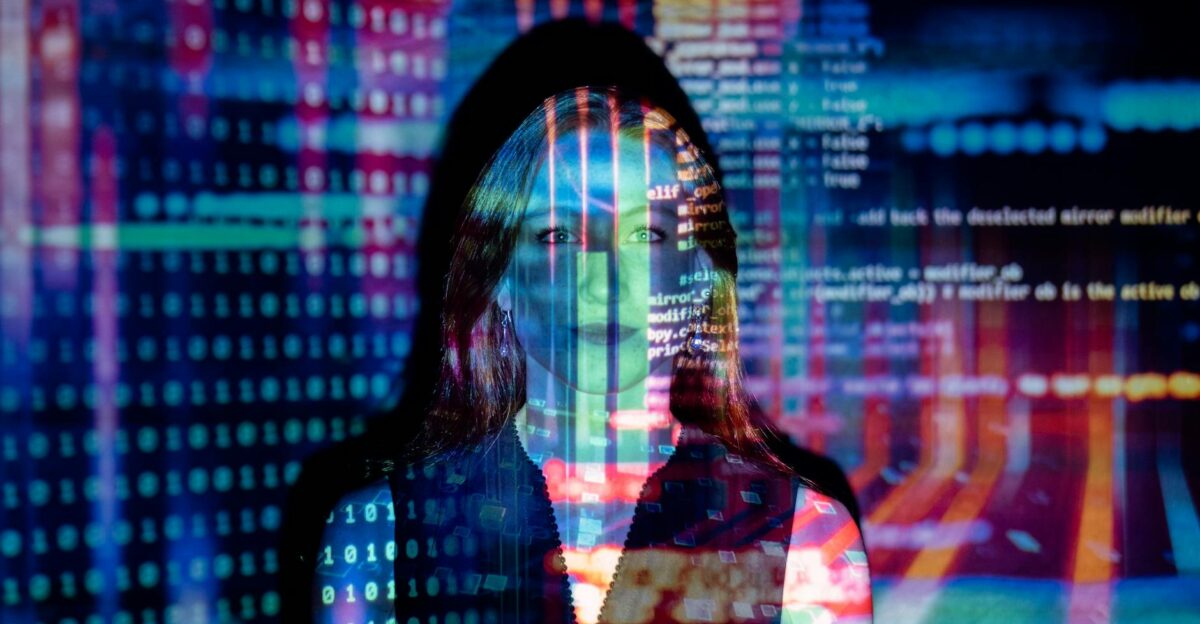 A woman with digital code projections on her face representing technology and future concepts
