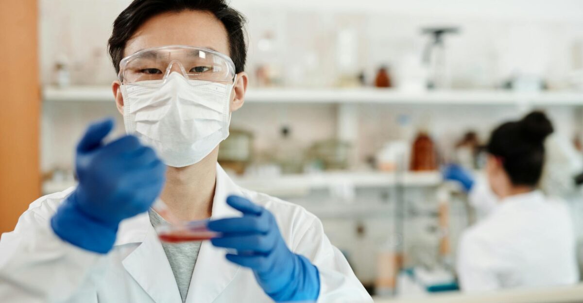Scientist in safety gear conducting an experiment in a laboratory