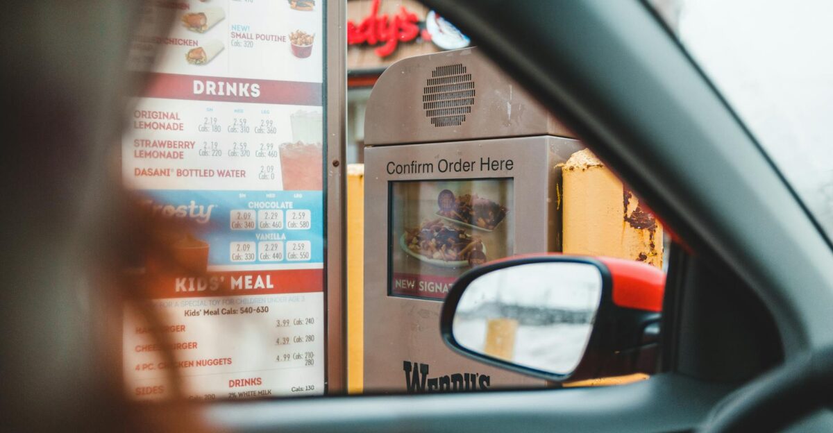 A customer interacts with a drive-thru menu to order fast food conveniently from their car