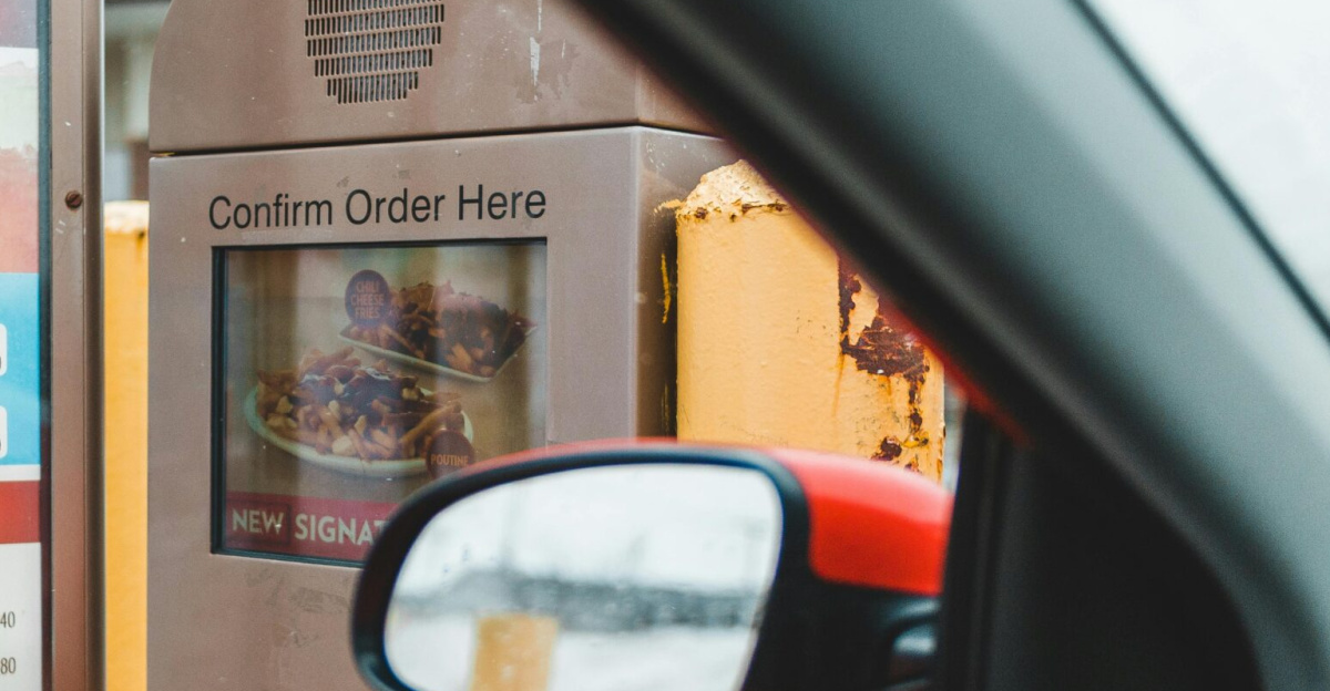 A customer interacts with a drive-thru menu to order fast food conveniently from their car.