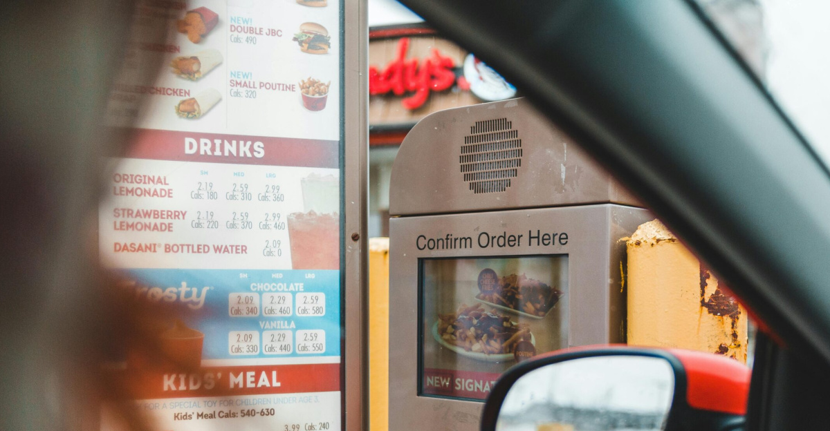 A customer interacts with a drive-thru menu to order fast food conveniently from their car.
