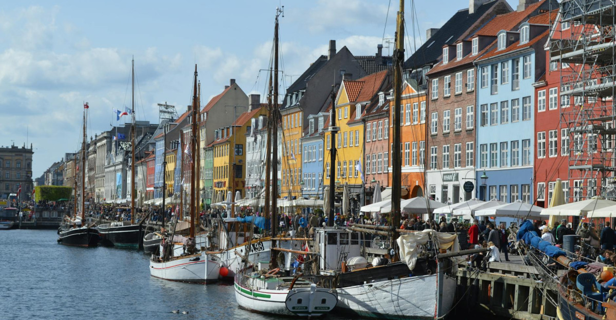 Vibrant waterfront scene of Nyhavn harbor with historic buildings and boats in Copenhagen