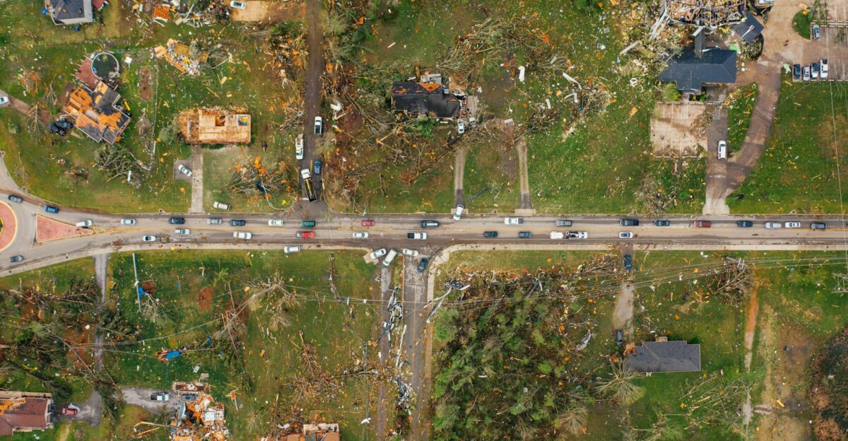 Aerial view of village houses ruined by wild storm near windthrown trees and electricity lines