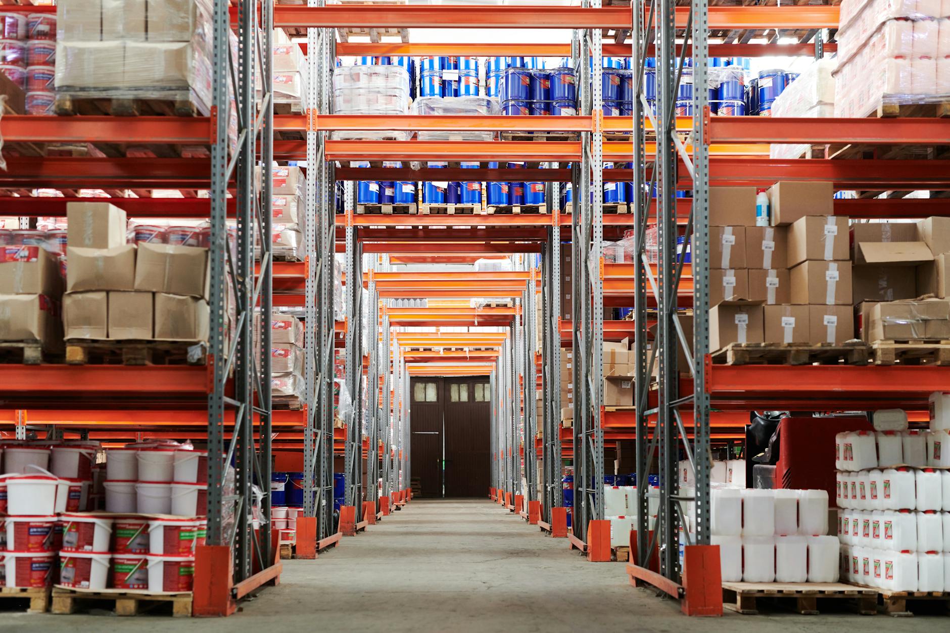 Wide angle view of a warehouse with stocked shelves and boxes
