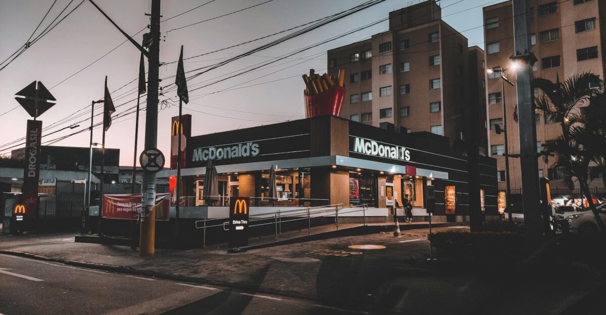Twilight view of a McDonald s restaurant in an urban area highlighting evening city life
