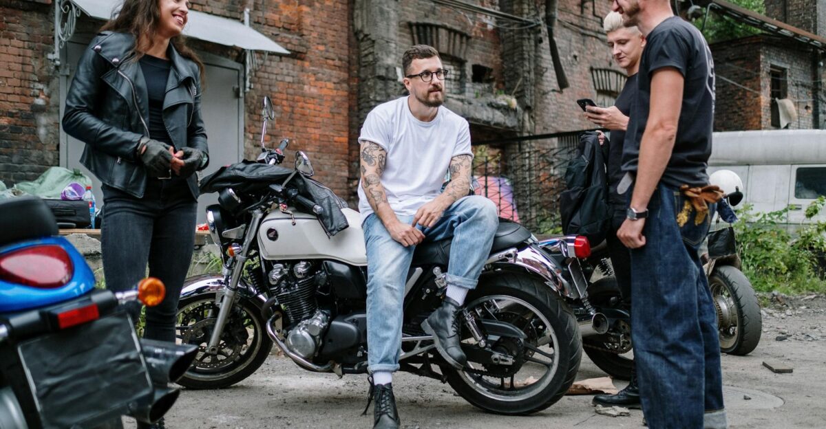 Casual gathering of motorcyclists socializing in an urban yard with motorcycles