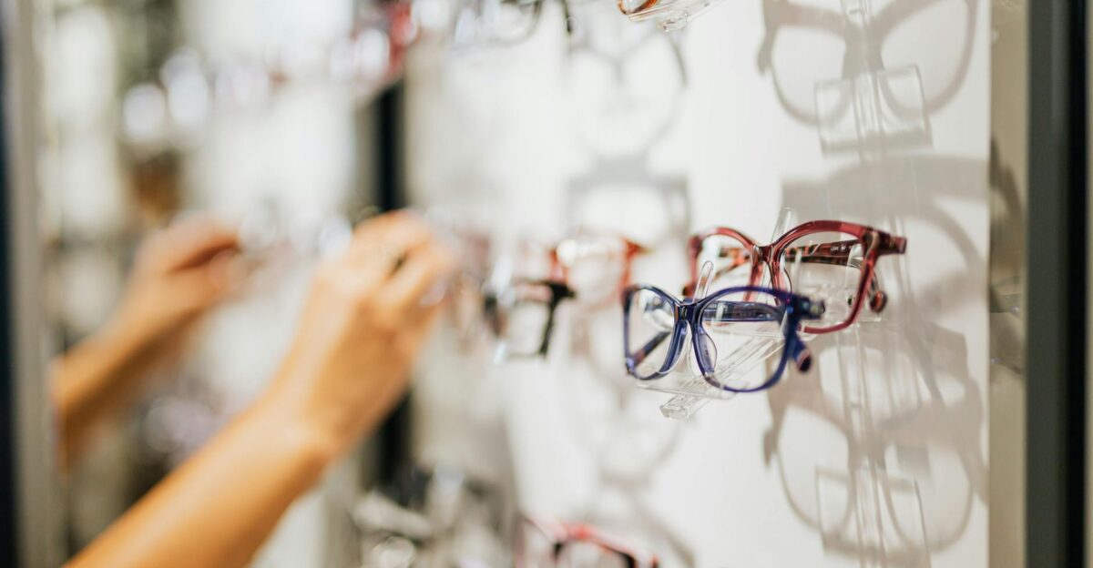 A variety of eyeglasses on display in a modern optical store showcasing different styles and colors