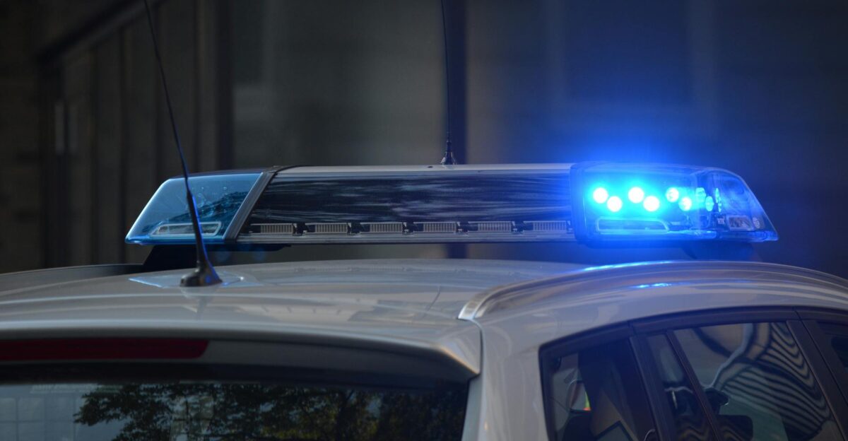 Close-up of a police car s flashing blue lights in an urban environment