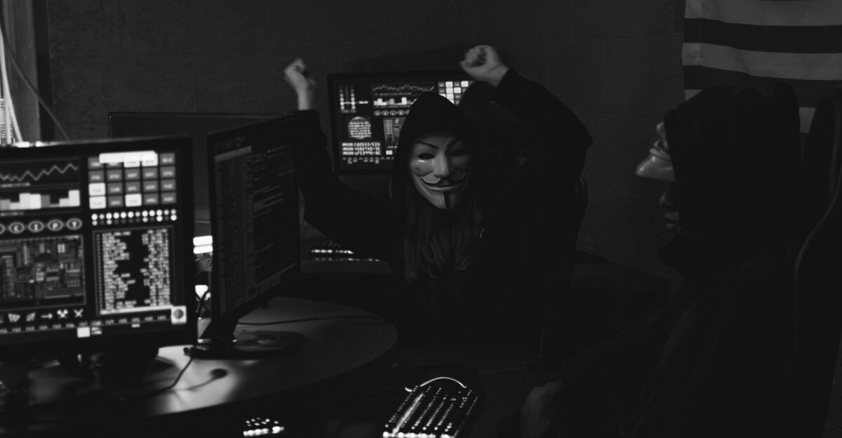 Hacker group with masks celebrating a successful cyber attack in a dimly lit room
