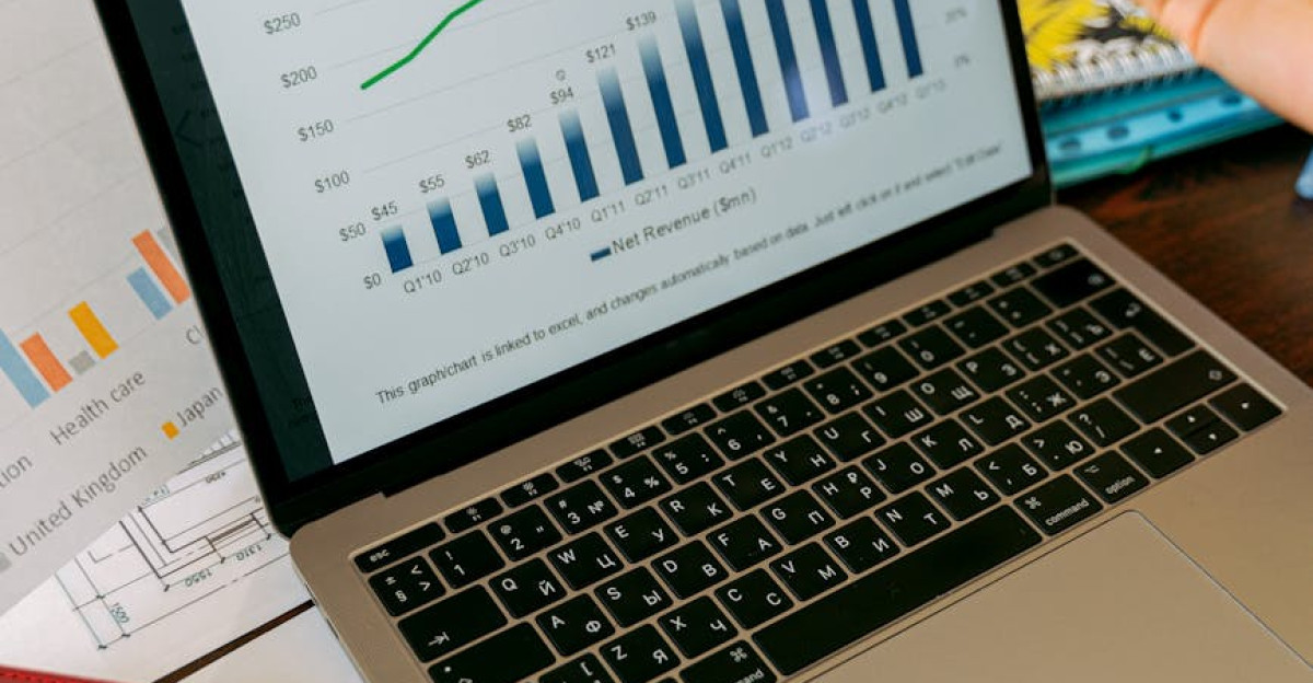 A close-up view of a laptop displaying business analytics and revenue charts