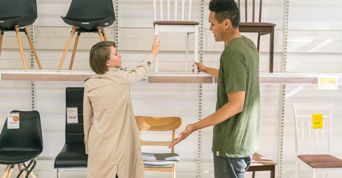 A couple explores chair options together in a modern furniture store during the day
