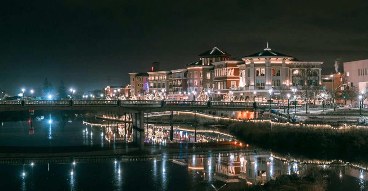 Illuminated buildings reflecting off the Napa River at night creating a serene cityscape