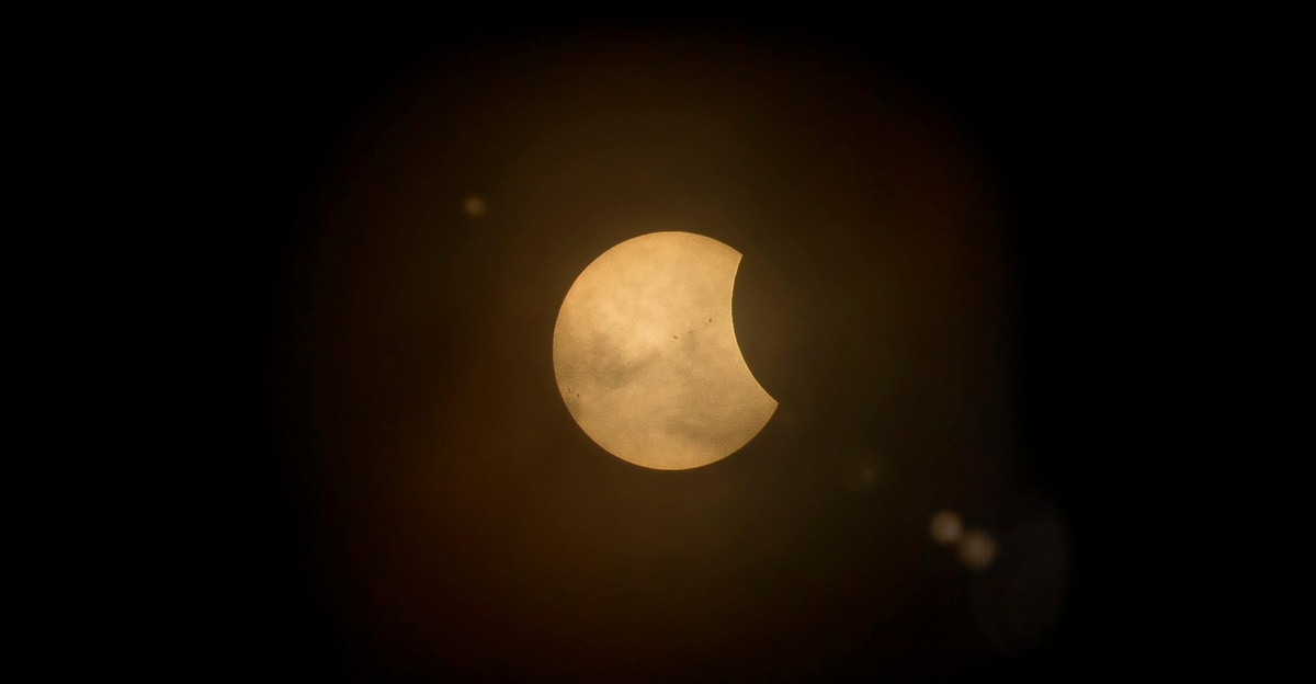 Captured partial solar eclipse set against a deep dark sky, perfect for astronomy enthusiasts.