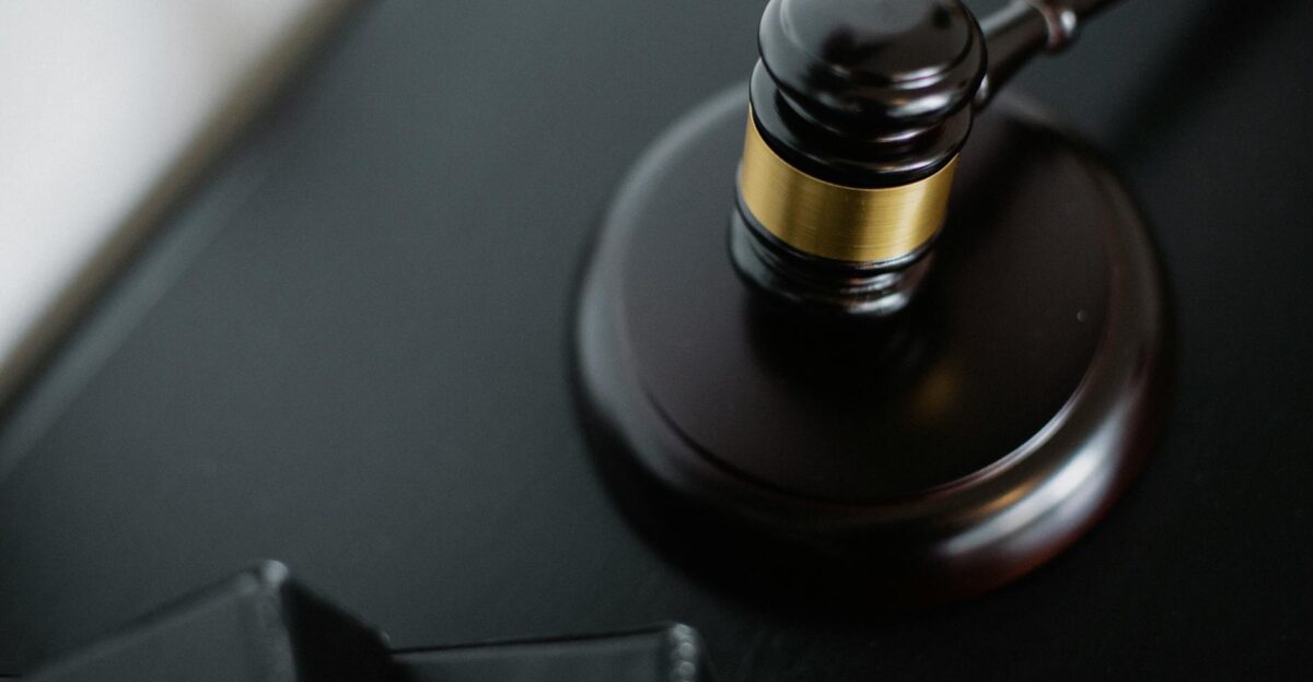 Close-up of a wooden judge s gavel on a black desk symbolizing justice and law