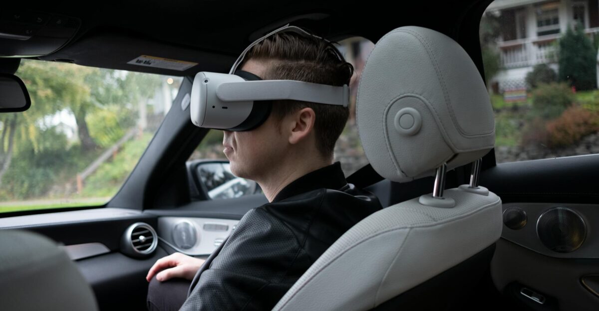 A man wearing VR goggles inside a luxury car enjoying a virtual reality experience