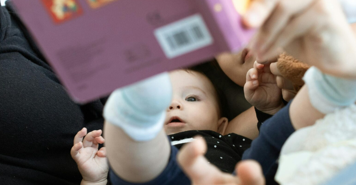 A baby and family reading together, promoting love and education. Cozy indoors setting.