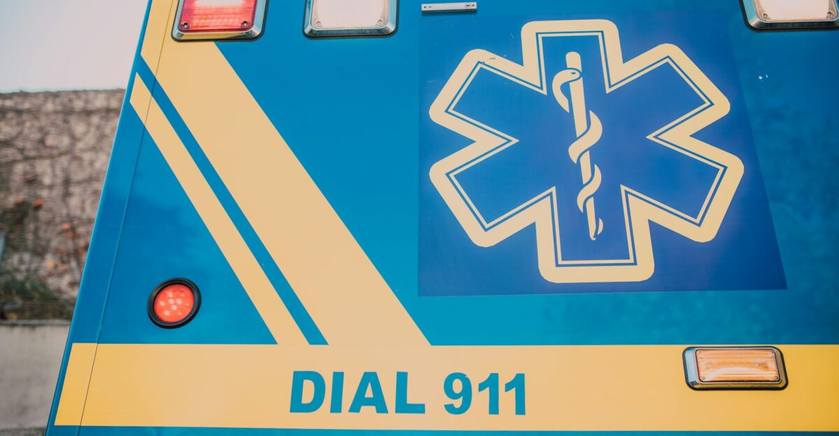 Close-up of an ambulance with star of life symbol and Dial 911 text