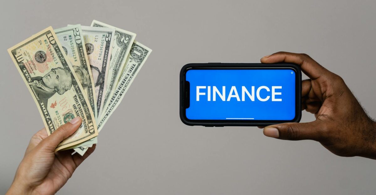 Image depicting currency and finance concept with hands holding cash and a smartphone