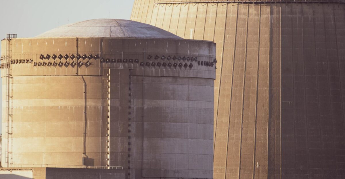 Close-up view of nuclear reactor buildings bathed in golden light showcasing industrial architecture