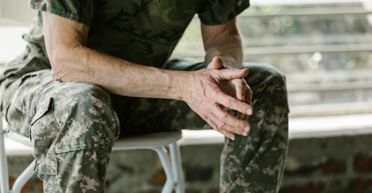 Close-up of a military veteran s hands in a therapy session emphasizing mental health support