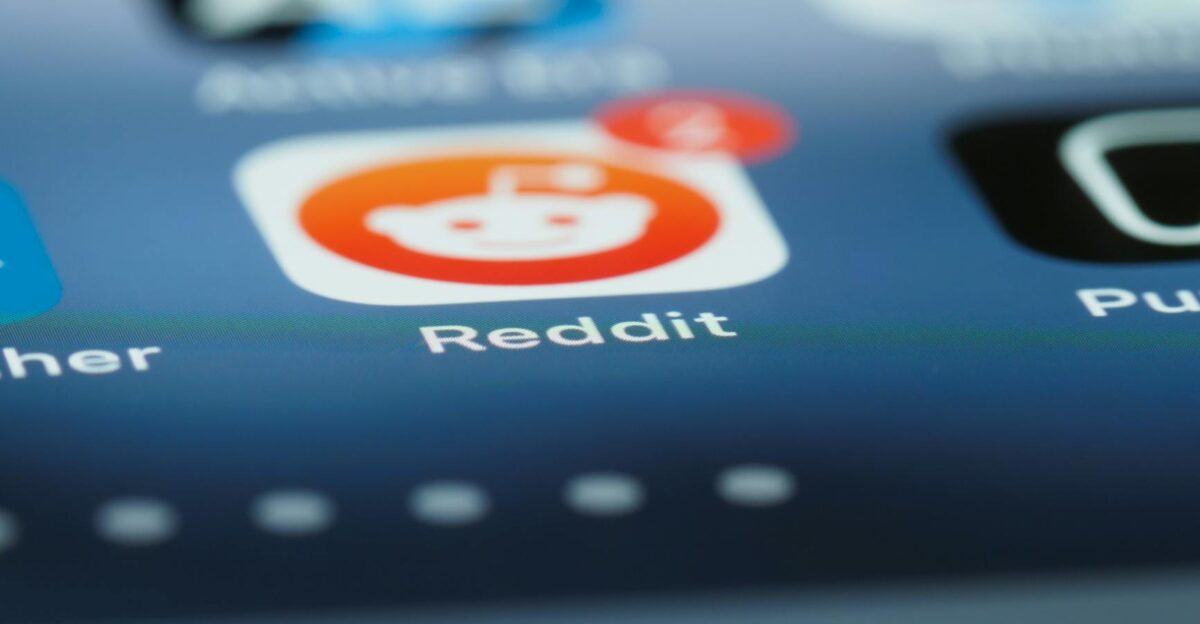 Detailed close-up of a smartphone screen showing the Reddit app with a notification badge