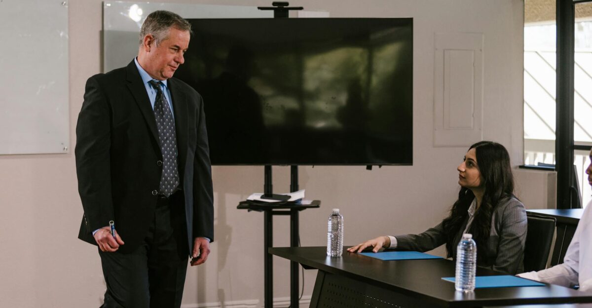 Professional business team engages in discussion during meeting in conference room