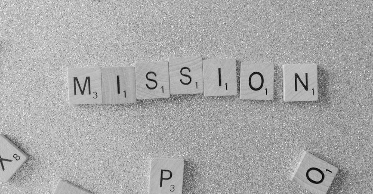 Scrabble tiles spelling MISSION on a glittery surface a symbolic and creative concept
