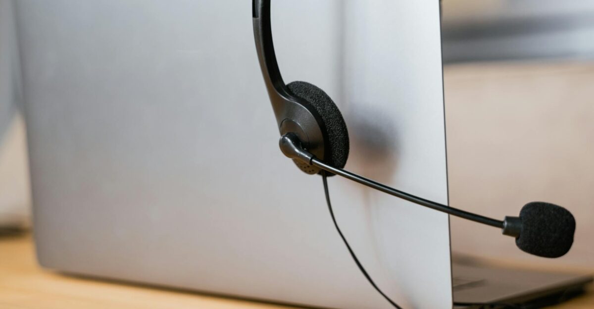 A laptop with a headset attached ideal for virtual meetings or online customer support