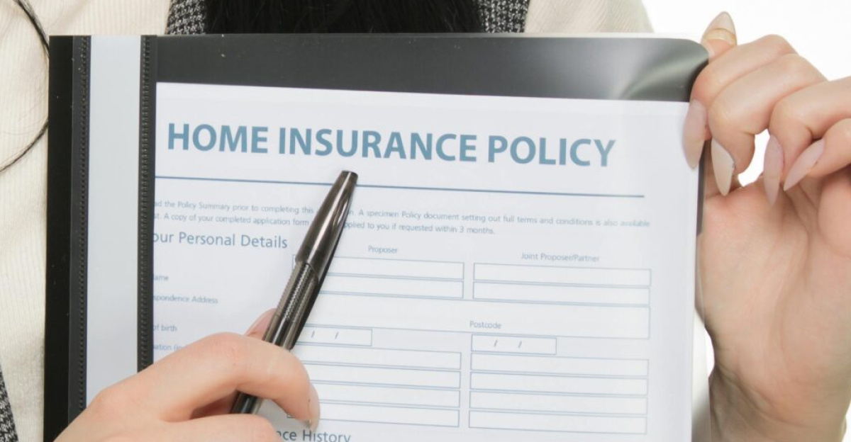 Young woman presenting a home insurance policy document while pointing with a pen.