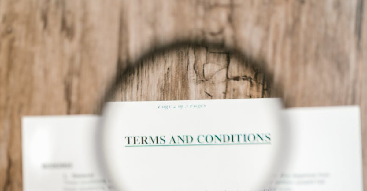 Magnifying glass focusing on Terms and Conditions in a document Ideal for business and legal themes
