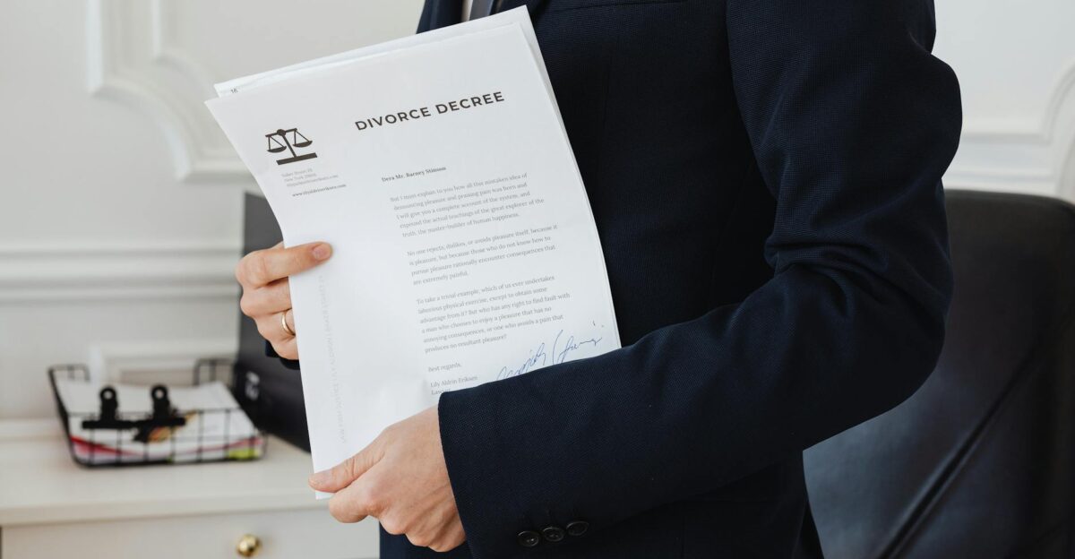 A person holding a divorce decree in an office setting symbolizing legal proceedings