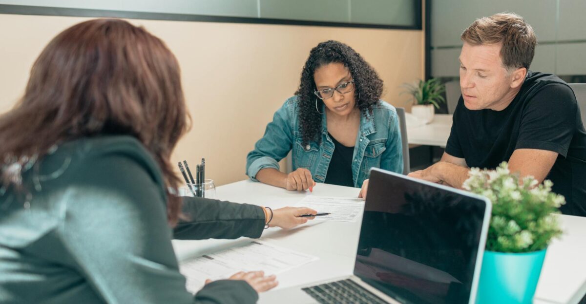 Couple meeting with advisor for adoption process in a modern office setting