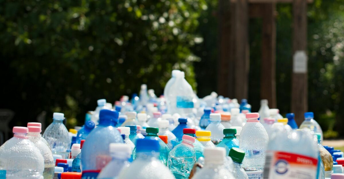A vibrant collection of plastic bottles in an outdoor recycling setup showcasing environmental awareness