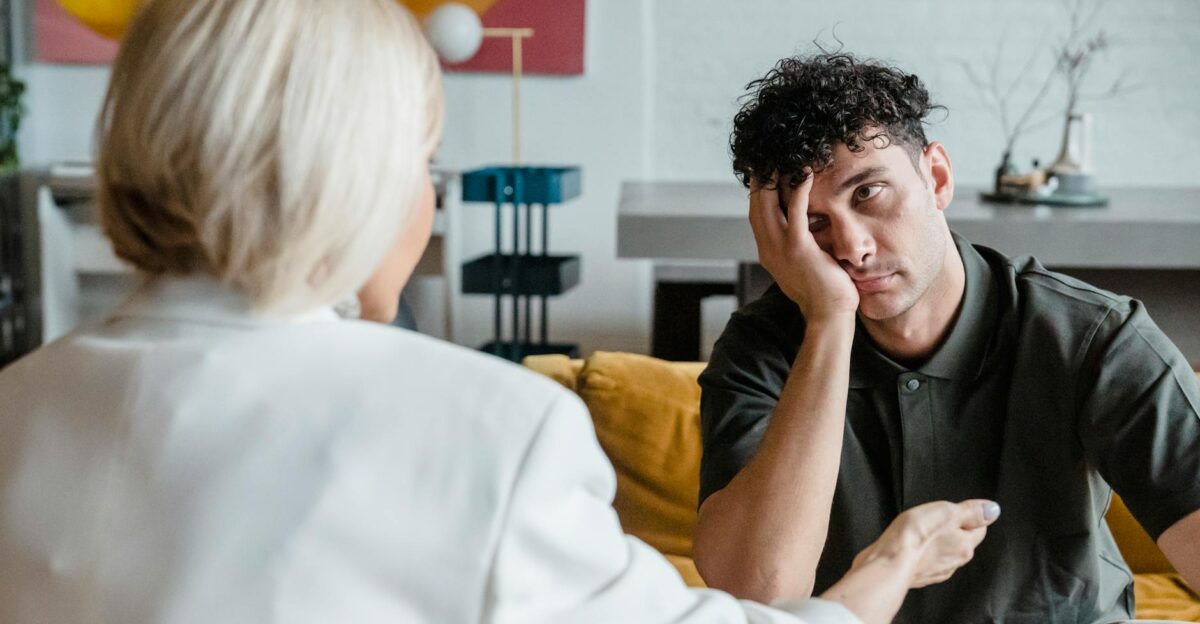 A therapist in session with a young man in a modern artistic office setting