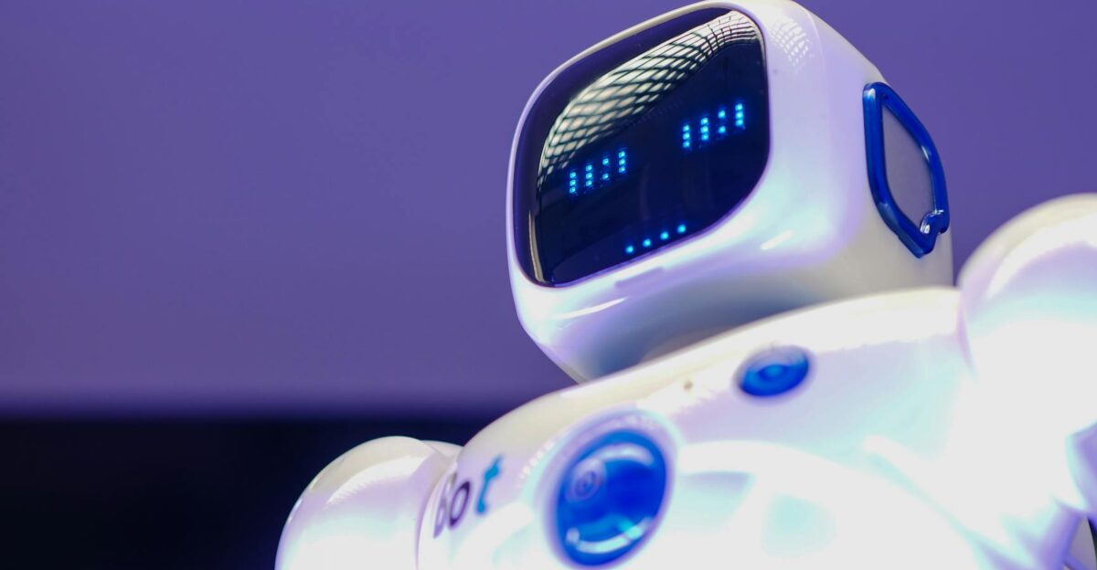 A modern humanoid robot with digital face and luminescent screen symbolizing innovation in technology