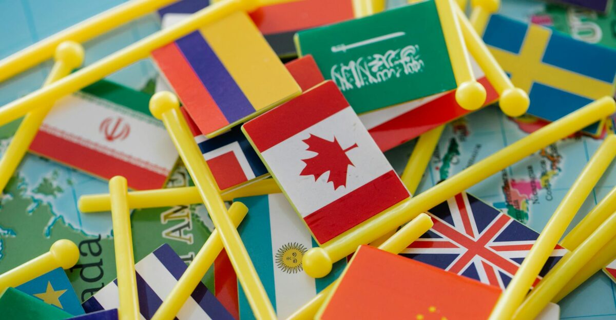 Colorful mini flags of countries on a world map symbolizing global connections