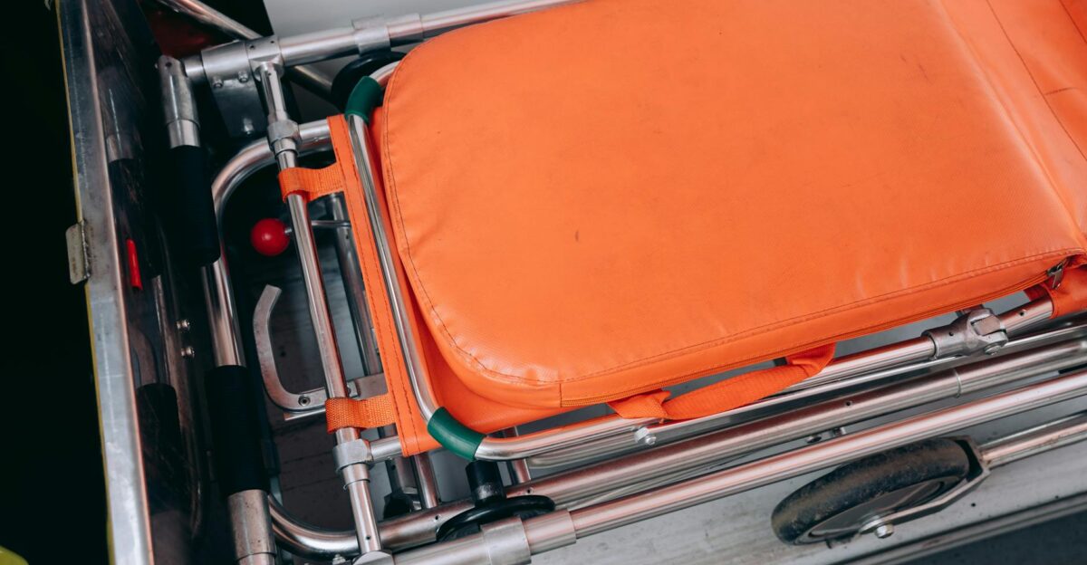 Close-up view of an orange stretcher inside an ambulance emphasizing medical equipment